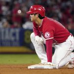 
              Los Angeles Angels designated hitter Shohei Ohtani kneels on second base after advancing from first on a single by Phil Gosselin during the third inning of a baseball game against the Seattle Mariners Saturday, Sept. 25, 2021, in Anaheim, Calif. (AP Photo/Mark J. Terrill)
            