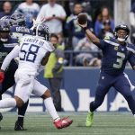 
              Seattle Seahawks quarterback Russell Wilson (3) passes to wide receiver Freddie Swain (not shown) for a touchdown against the Tennessee Titans during the second half of an NFL football game, Sunday, Sept. 19, 2021, in Seattle. (AP Photo/Elaine Thompson)
            