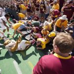 
              Minnesota fans collapse the fence around the field and trap masoct Goldy the Golden Gopher after an NCAA college football game against Colorado Saturday, Sept. 18, 2021, in Boulder, Colo. Minnesota won 30-0. (AP Photo/David Zalubowski)
            