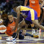 
              Connecticut Sun forward DeWanna Bonner (24) and Los Angeles Sparks guard Erica Wheeler (17) dive after a loose ball during the second half of WNBA basketball game Thursday, Sept. 9, 2021, in Los Angeles. (AP Photo/Ashley Landis)
            