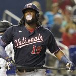 
              Washington Nationals' Josh Bell (19) blows a bubble after striking out in the second inning of a baseball game against the Miami Marlins, Monday, Sept. 20, 2021, in Miami. (AP Photo/Marta Lavandier)
            