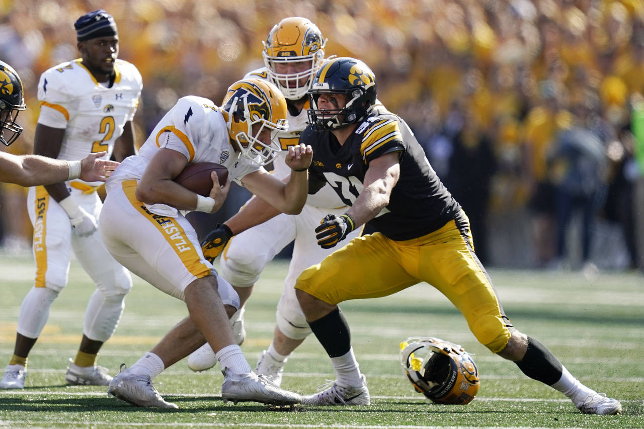 FILE - Kent State quarterback Dustin Crum (7) is sacked by Iowa linebacker Jack Campbell (31) durin...