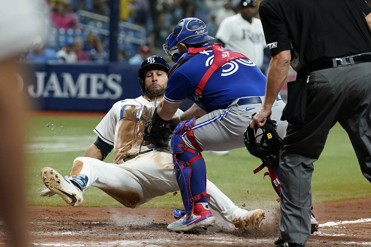 Toronto Blue Jays catcher Alejandro Kirk (30) tags out Tampa Bay Rays' Kevin Kiermaier trying to sc...