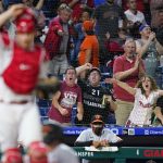 
              Fans react after Baltimore Orioles' Pedro Severino was tagged out at home by Philadelphia Phillies catcher J.T. Realmuto after trying to score on a single by Pat Valaika during the eighth inning of an interleague baseball game, Wednesday, Sept. 22, 2021, in Philadelphia. (AP Photo/Matt Slocum)
            