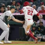 
              Los Angeles Angels' David Fletcher (22) is tagged out by Oakland Athletics first baseman Matt Olson during the seventh inning of a baseball game Friday, Sept. 17, 2021, in Anaheim, Calif. (AP Photo/Ashley Landis)
            