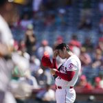 
              Los Angeles Angels starting pitcher Shohei Ohtani, right, of Japan, adjusts his cap after giving up a home run to Oakland Athletics' Yan Gomes, foreground, during the third inning of a baseball game Sunday, Sept. 19, 2021, in Anaheim, Calif. (AP Photo/Jae C. Hong)
            