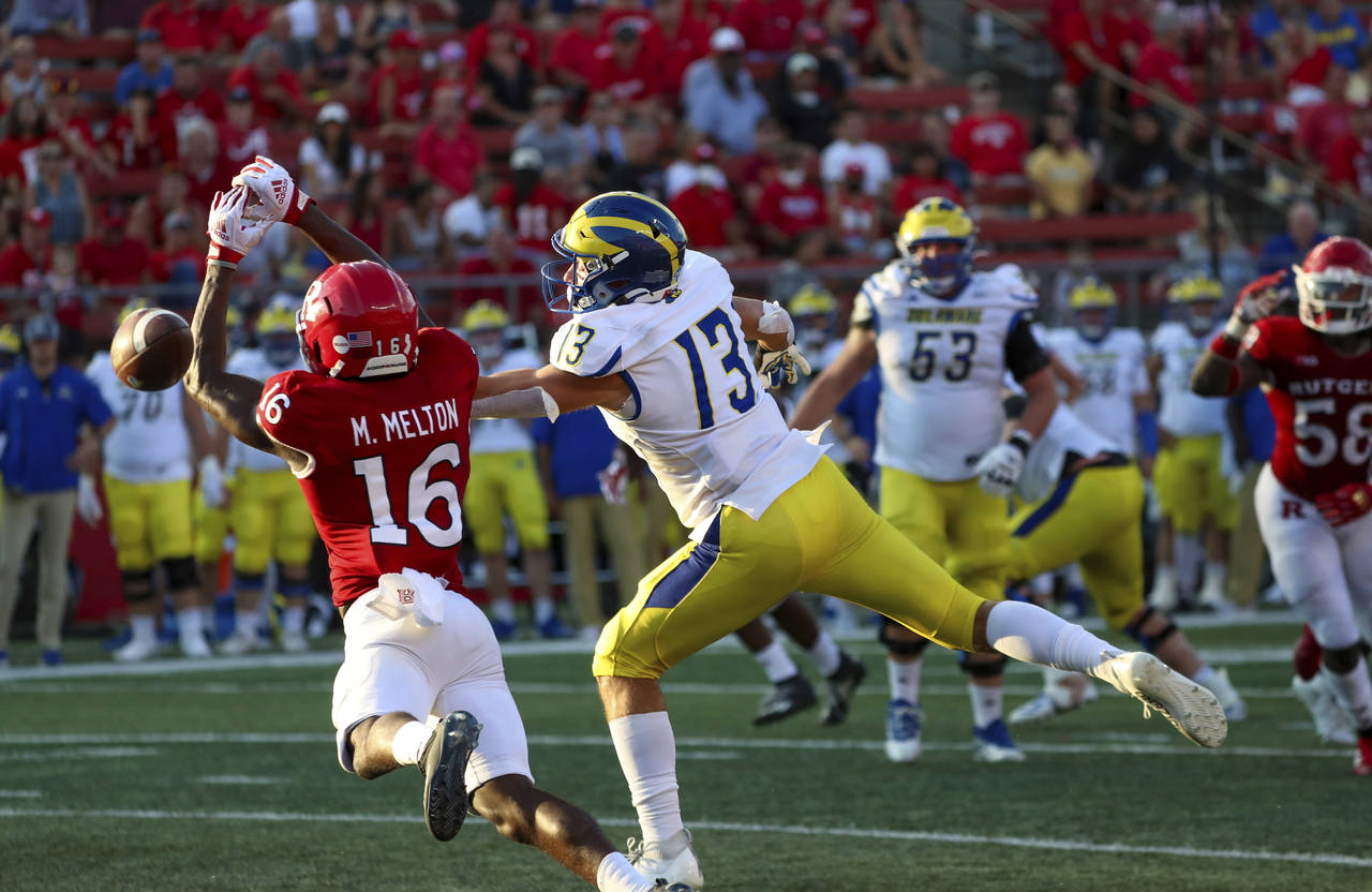 Rutgers defensive back Max Melton (16) makes a play on a pass intended for Delaware wide receiver B...