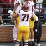 
              Southern California wide receiver Gary Bryant Jr. (1) celebrates his touchdown with tight end Jude Wolfe (18) and offensive lineman Liam Jimmons (71) during the second half of an NCAA college football game, Saturday, Sept. 18, 2021, in Pullman, Wash. Southern California won 45-14. (AP Photo/Young Kwak)
            