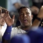 
              Kansas City Royals' Salvador Perez celebrates in the dugout after scoring on a sacrifice fly hit by Carlos Santana during the fourth inning of a baseball game against the Cleveland Indians Tuesday, Sept. 28, 2021, in Kansas City, Mo. (AP Photo/Charlie Riedel)
            