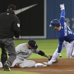 
              Toronto Blue Jays' Corey Dickerson (14) slides into second base with a steal ahead of a tag by New York Yankees' Gleyber Torres during the fourth inning of a baseball game in Toronto on Thursday, Sept. 30, 2021.  (Jon Blacker/The Canadian Press via AP)
            