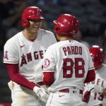 
              Los Angeles Angels designated hitter Shohei Ohtani, right, laughs at the bat boy after being intentionally walked during the ninth inning of a baseball game against the Seattle Mariners Friday, Sept. 24, 2021, in Anaheim, Calif. (AP Photo/Mark J. Terrill)
            