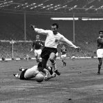 
              FILE - In this Oct. 23, 1965 file photo, England inside-right Jimmy Greaves vies for the ball against Yugoslav goalkeeper Milutin Soskic during the second half of the Football Association football match between England and the Rest of the World at Wembley Stadium, London. Jimmy Greaves, one of England’s greatest goal-scorers who was prolific for Tottenham, Chelsea and AC Milan has died. He was 81. With 266 goals in 379 appearances, Greaves was the all-time record scorer for Tottenham, which announced his death on Sunday, Sept. 19, 2021. (AP Photo/Robert Rider-Rider, File)
            