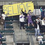 
              Seattle Mariners fans in the bleachers dance to music near a sign that reads "believe" in the fourth inning of a baseball game against the Oakland Athletics Tuesday, Sept. 28, 2021, in Seattle. (AP Photo/Jason Redmond)
            