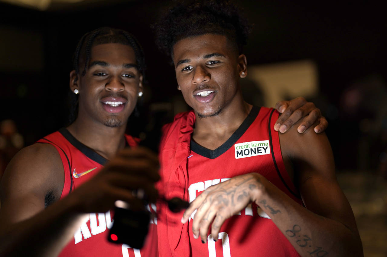 Houston Rockets' Jalen Green, right, and Josh Christopher film themselves during an NBA basketball ...
