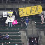 
              Seattle Mariners fans stand next to a "Believe" sign during a baseball game against the Oakland Athletics, Wednesday, Sept. 29, 2021, in Seattle. Fans and the team have adopted the one-word slogan that was recently featured on the TV series "Ted Lasso" as the Mariners battle for a spot in the MLB playoffs. (AP Photo/Ted S. Warren)
            