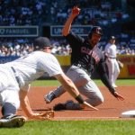 
              Cleveland Indians' Bradley Zimmer, right, dives safely into third base as New York Yankees' DJ LeMahieu tries to tag him out in the first inning of a baseball game, Sunday, Sept. 19, 2021, in New York. (AP Photo/Eduardo Munoz Alvarez)
            