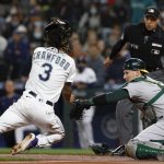 
              Oakland Athletics catcher Sean Murphy goes for the tag on Seattle Mariners' J.P. Crawford for the out at home plate in the first inning of a baseball game Tuesday, Sept. 28, 2021, in Seattle. (AP Photo/Jason Redmond)
            
