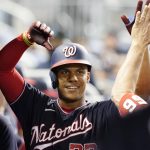 
              Washington Nationals' Juan Soto is cheered by the team after hitting a two-run home run in the third inning of a baseball game against the Miami Marlins, Wednesday, Sept. 22, 2021, in Miami. (AP Photo/Marta Lavandier)
            