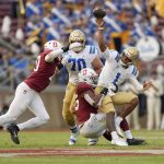 
              UCLA quarterback Dorian Thompson-Robinson (1) is pressured by Stanford linebacker Ricky Miezan, center, and linebacker Jordan Fox, left, during the second half of an NCAA college football game Saturday, Sept. 25, 2021, in Stanford, Calif. (AP Photo/Tony Avelar)
            