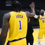 
              Los Angeles Lakers forward LeBron James, right, high-fives teammate Trevor Ariza during the NBA basketball team's Media Day Tuesday, Sept. 28, 2021, in El Segundo, Calif. (AP Photo/Marcio Jose Sanchez)
            