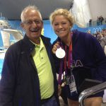 
              In this July 2012 photo provided by Joan Beisel, Olympic medalist swimmer Elizabeth Beisel, right, stands for a photo with her father Ted Beisel, left, at the 2012 Olympics, in London. Beisel competed in three Olympics, but she's never taken on a challenge quite like this. She will attempt to become the first woman to swim from the Rhode Island mainland to Block Island. The 10.4-mile swim is to honor her father, who died July 1 after being diagnosed with pancreatic cancer. Beisel has raised more than $121,000 for the fight against cancer and knows that she brought some meaning to her father's life in his final months. (Joan Beisel via AP)
            