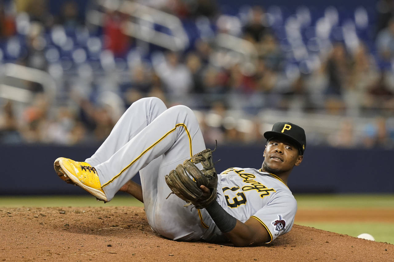 Pittsburgh Pirates third baseman Ke'Bryan Hayes (13) lies on the pitcher's mound after he fell whil...
