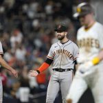 
              San Francisco Giants third baseman Evan Longoria, center, reacts with relief pitcher Tyler Rogers (71) after the Giants defeated the San Diego Padres 6-5 in a baseball game Tuesday, Sept. 21, 2021, in San Diego. (AP Photo/Gregory Bull)
            
