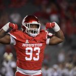 
              Houston defensive lineman Atlias Bell (93) reacts to sacking Navy's Maasai Maynor during the second half of an NCAA college football game, Saturday, Sept. 25, 2021, in Houston. (AP Photo/Justin Rex)
            