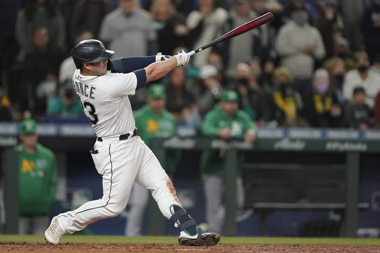 Seattle Mariners' Ty France hits a sacrifice fly to score Dylan Moore during the seventh inning of ...