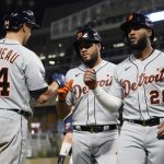 
              Detroit Tigers' Niko Goodrum (28), Jeimer Candelario, center, and Harold Castro (30) are greeted by Dustin Garneau (64) following Goodrum's three run home run off Minnesota Twins pitcher Joe Ryan in the fourth inning of a baseball game, Thursday, Sept. 30, 2021, in Minneapolis. (AP Photo/Jim Mone)
            