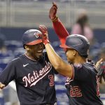 
              Washington Nationals' Alcides Escobar (3) cheers Juan Soto (22) after Soto hit a two-run home run during the third inning of a baseball game against the Miami Marlins, Wednesday, Sept. 22, 2021, in Miami. (AP Photo/Marta Lavandier)
            