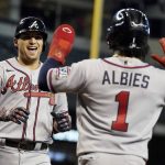 
              CORRECTS TO AUSTIN RILEY NOT FREDDIE FREEMAN - Atlanta Braves' Austin Riley, left, laughs as Ozzie Albies (1) waits to congratulate him after he hit a two-run home run against the Arizona Diamondbacks during the third inning of a baseball game Thursday, Sept 23, 2021, in Phoenix. (AP Photo/Darryl Webb)
            