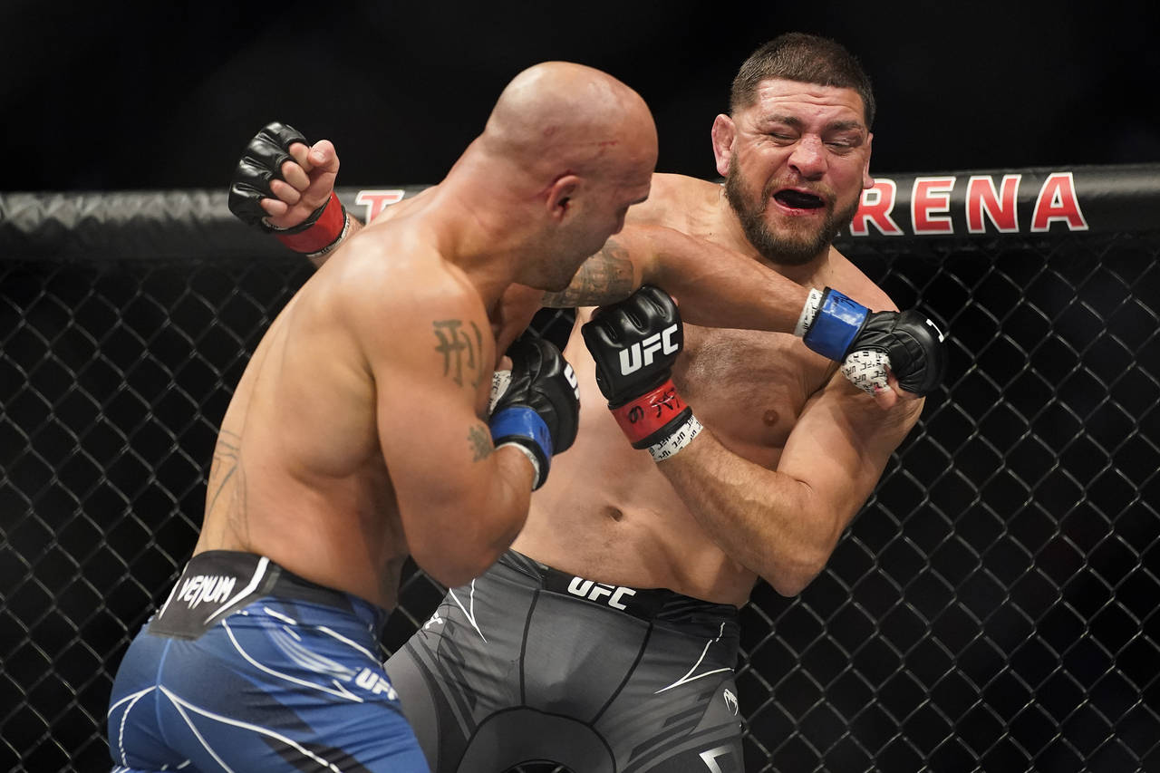 Robbie Lawler, left, throws a punch against Nick Diaz during a middleweight mixed martial arts bout...
