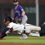 
              Atlanta Braves second baseman Ozzie Albies (1) slides into second before being tagged out in the fifth inning of a baseball game against the Colorado Rockies Tuesday, Sept. 14, 2021, in Atlanta. (AP Photo/John Bazemore)
            