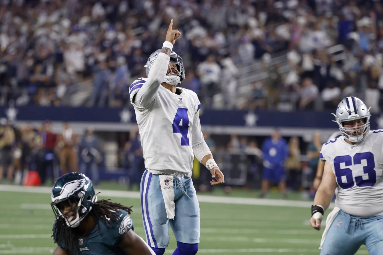 Dallas Cowboys quarterback Dak Prescott (4) and center Tyler Biadasz (63) celebrate a touchdown sco...