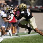 
              Minnesota running back Treyson Potts, left, is stopped by Colorado safety Isaiah Lewis in the first half of an NCAA college football game Saturday, Sept. 18, 2021, in Boulder, Colo. (AP Photo/David Zalubowski)
            