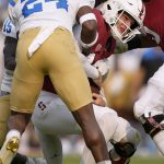 
              Stanford quarterback Tanner McKee (18) is sacked by UCLA defensive back Qwuantrezz Knight (24) during the first half of an NCAA college football game Saturday, Sept. 25, 2021, in Stanford, Calif. (AP Photo/Tony Avelar)
            