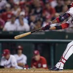 
              Washington Nationals' Alcides Escobar hits an RBI double during the fifth inning of a baseball game against the Miami Marlins at Nationals Park, Tuesday, Sept. 14, 2021, in Washington. (AP Photo/Alex Brandon)
            