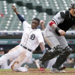 
              Detroit Tigers' Daz Cameron scores behind Chicago White Sox catcher Yasmani Grandal during the fourth inning of a baseball game Tuesday, Sept. 21, 2021, in Detroit. (AP Photo/Duane Burleson)
            