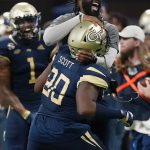 
              Georgia Tech defensive lineman Makius Scott (90) celebrates with defensive line coach Larry Knight after a defensive stop during the first half of an NCAA college football game against North Carolina Saturday, Sept. 25, 2021, in Atlanta. (AP Photo/John Bazemore)
            