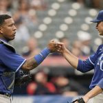 
              Kansas City Royals starting pitcher Brady Singer, right, celebrates with catcher Salvador Perez after they defeated the Cleveland Indians in the first baseball game of a doubleheader, Monday, Sept. 20, 2021, in Cleveland. (AP Photo/Tony Dejak)
            