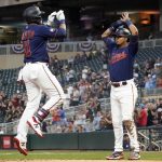 
              Minnesota Twins' Jorge Polanco, left, celebrates his three-run home run off Detroit Tigers pitcher Casey Mize with teamamte Luis Arraezz, right, in the first inning of a baseball game, Wednesday, Sept. 29, 2021, in Minneapolis. (Photo by Jim Mone)
            
