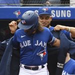 
              Toronto Blue Jays' Breyvic Valera, right, puts The Blue Jacket on Bo Bichette after Bichette hit a three-run home run in the first inning of a baseball game against the Tampa Bay Rays in Toronto on Wednesday, Sept. 15, 2021. (Jon Blacker/The Canadian Press via AP)
            