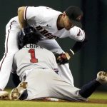 
              Atlanta Braves' Ozzie Albies (1) collides with Arizona Diamondbacks second baseman Josh VanMeter, top, during a steal-attempt in which he was out during the fifth inning of a baseball game Thursday, Sept 23, 2021, in Phoenix. (AP Photo/Darryl Webb)
            