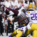 
              Mississippi State wide receiver Malik Heath (4) fumbles as he is upended by LSU cornerback Cordale Flott (25) during the first half of an NCAA college football game, Saturday, Sept. 25, 2021, in Starkville, Miss. (AP Photo/Rogelio V. Solis)
            