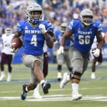 
              Memphis wide receiver Calvin Austin III (4) runs for a touchdown as offensive lineman Dylan Parham (56) follows during the second half of an NCAA college football game against Mississippi State, Saturday, Sept. 18, 2021, in Memphis, Tenn. (AP Photo/John Amis)
            