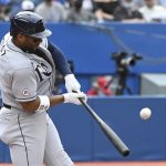
              Tampa Bay Rays' Yandy Diaz hits a double in the first inning  in the first inning of a baseball game against the Toronto Blue Jays in Toronto on Wednesday, Sept. 15, 2021. (Jon Blacker/The Canadian Press via AP)
            