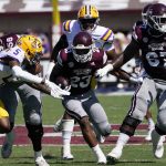 
              Mississippi State running back Dillon Johnson (23) rushes for short yardage as LSU safety Jay Ward (5) pursues during the first half of an NCAA college football game, Saturday, Sept. 25, 2021, in Starkville, Miss. (AP Photo/Rogelio V. Solis)
            
