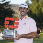 
              Max Homa poses with his trophy on the 18th green of the Silverado Resort North Course after winning the Fortinet Championship PGA golf tournament Sunday, Sept. 19, 2021, in Napa, Calif. (AP Photo/Eric Risberg)
            