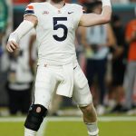 
              Virginia Cavaliers quarterback Brennan Armstrong (5) aims a pass during the first half of a NCAA college football game against the Miami Hurricanes, Thursday, Sept. 30, 2021, in Miami Gardens, Fla. (AP Photo/Lynne Sladky)
            